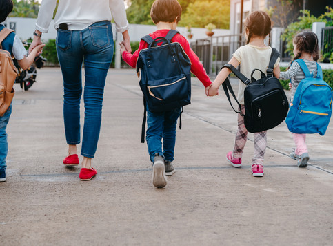 children holding hands while walking