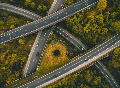 Cross roads, cars and forest aerial view