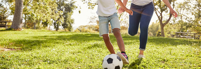 a girl and her mother playing soccer