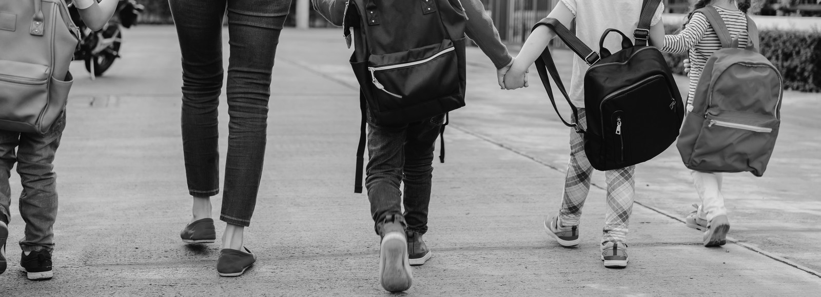 children holding hands while walking