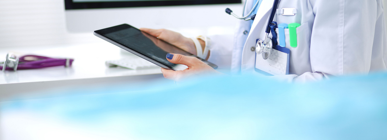 Image of a doctor holding a tablet
